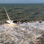 The sailboat French Kiss is battered on the Galveston